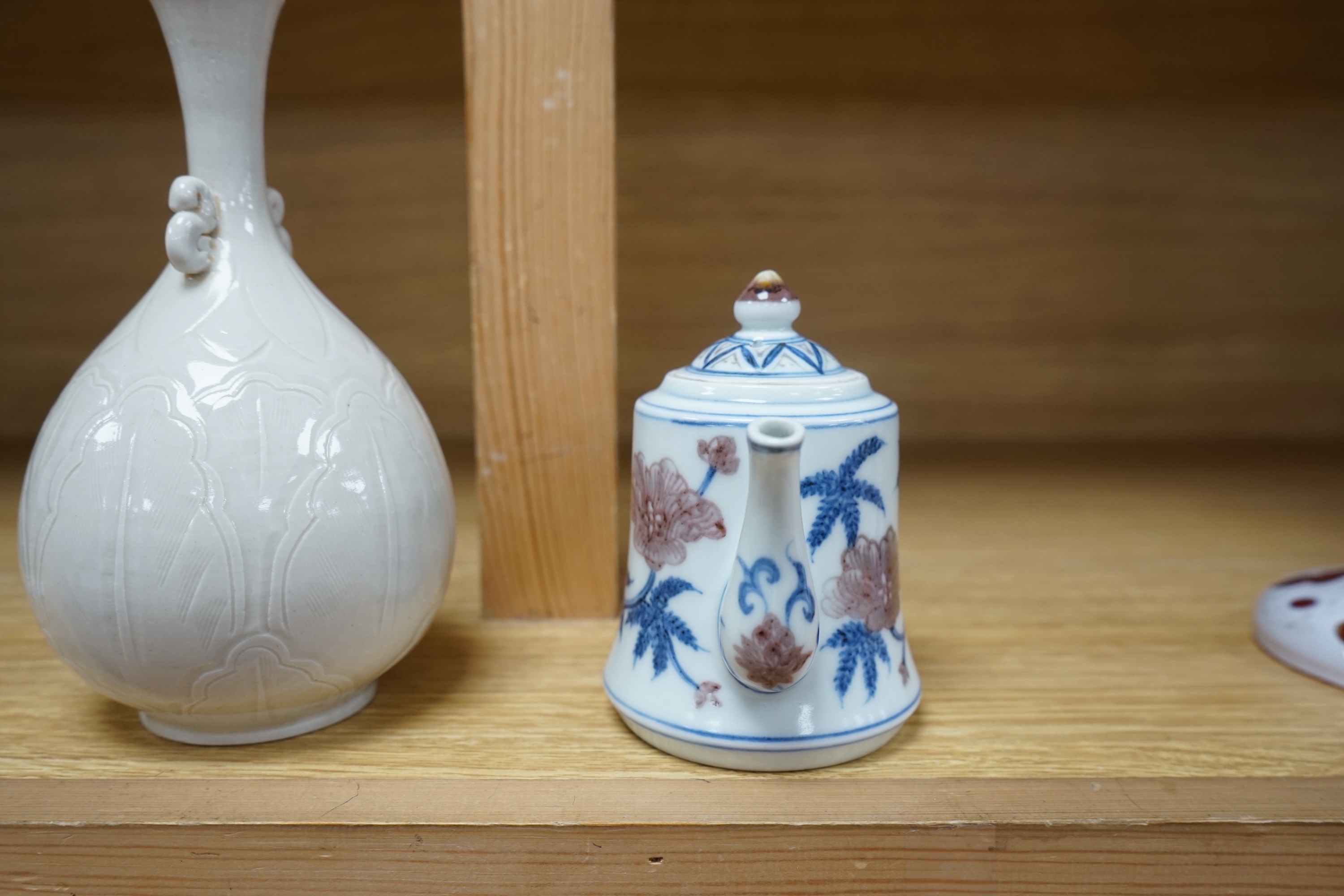 A Chinese carved bottle vase, 18cm high, and a small teapot. Condition - fair to good.